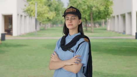 portrait of indian female security guard standing crossed hands