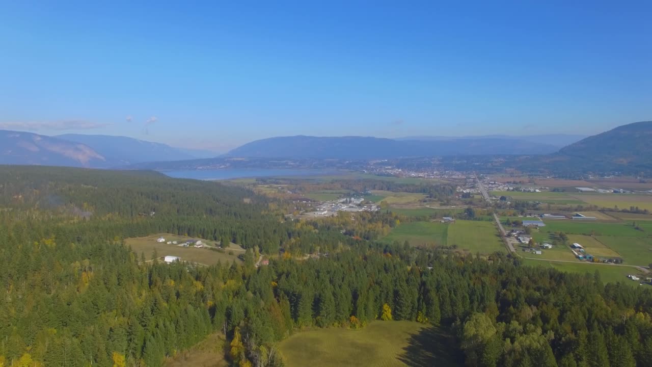 Suburban landscape with river and view of the mountains in the background. Above river bed.