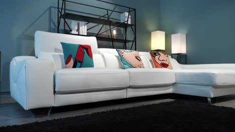 slow orbiting shot of a clean white sofa with funk faces on cushions in a living room