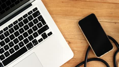 Laptop,-mobile-phone,-stethoscope-and-disposable-cup