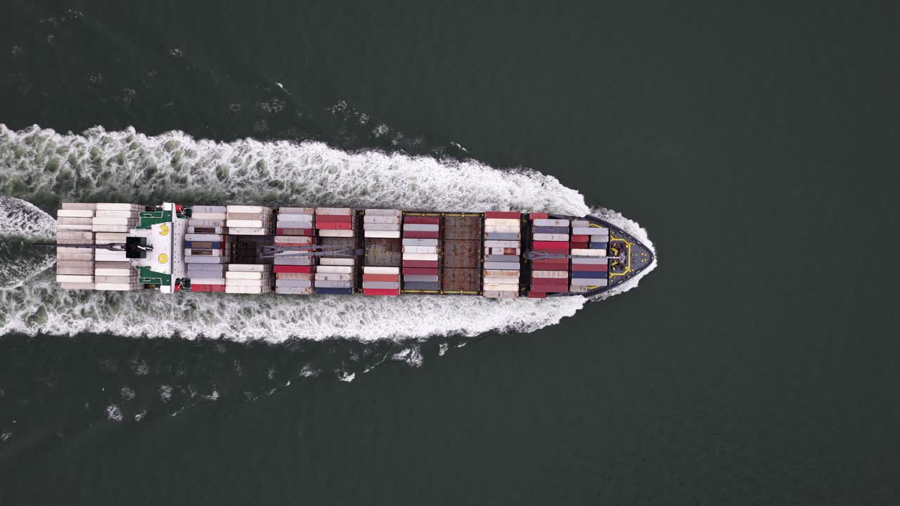 Container ship in front of the port of Vlissingen. Aerial drone video. Transport and logistics