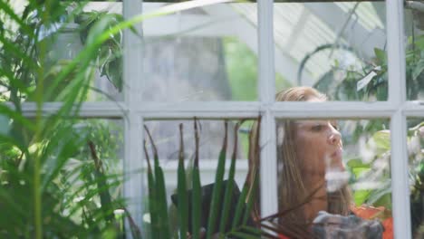 Woman gardening in a greenhouse