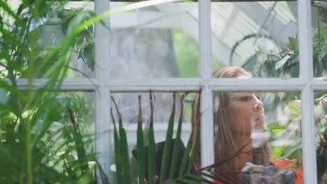 woman gardening in a greenhouse