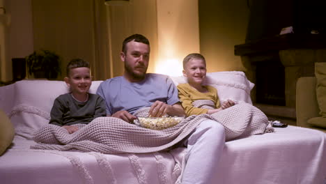 father and sons watching movie