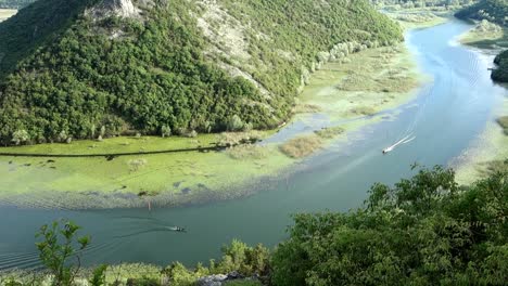 small boats sailing on curvy stretch of river crnojevica. montenegro, europe