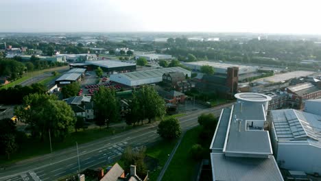 modern retail warehouse buildings aerial view of outskirts suburban town centre townscape parkland