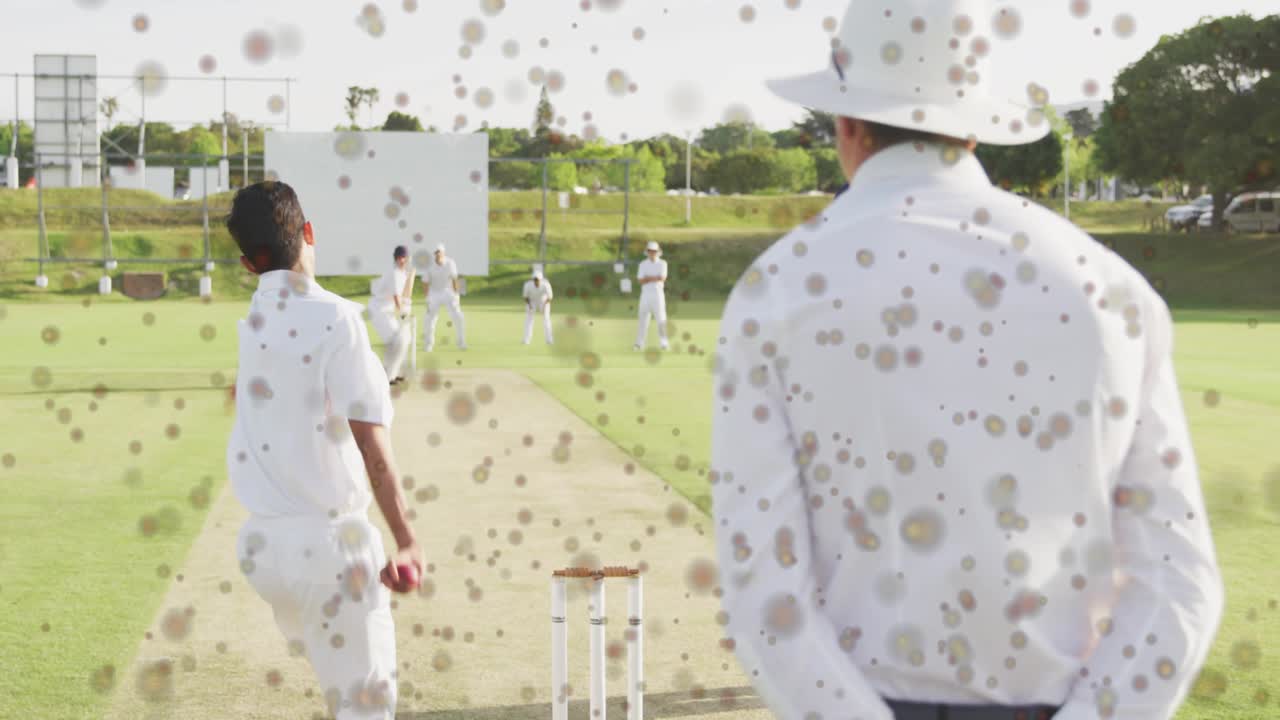 Umpire watching bowler starting run-up, bowling at batsman for sports, speckle overlay hiding pitch