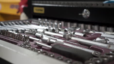 man's hand organizing tools in a toolbox