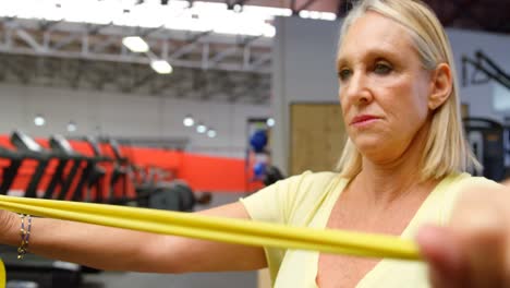 woman doing exercise with resistance band 4k