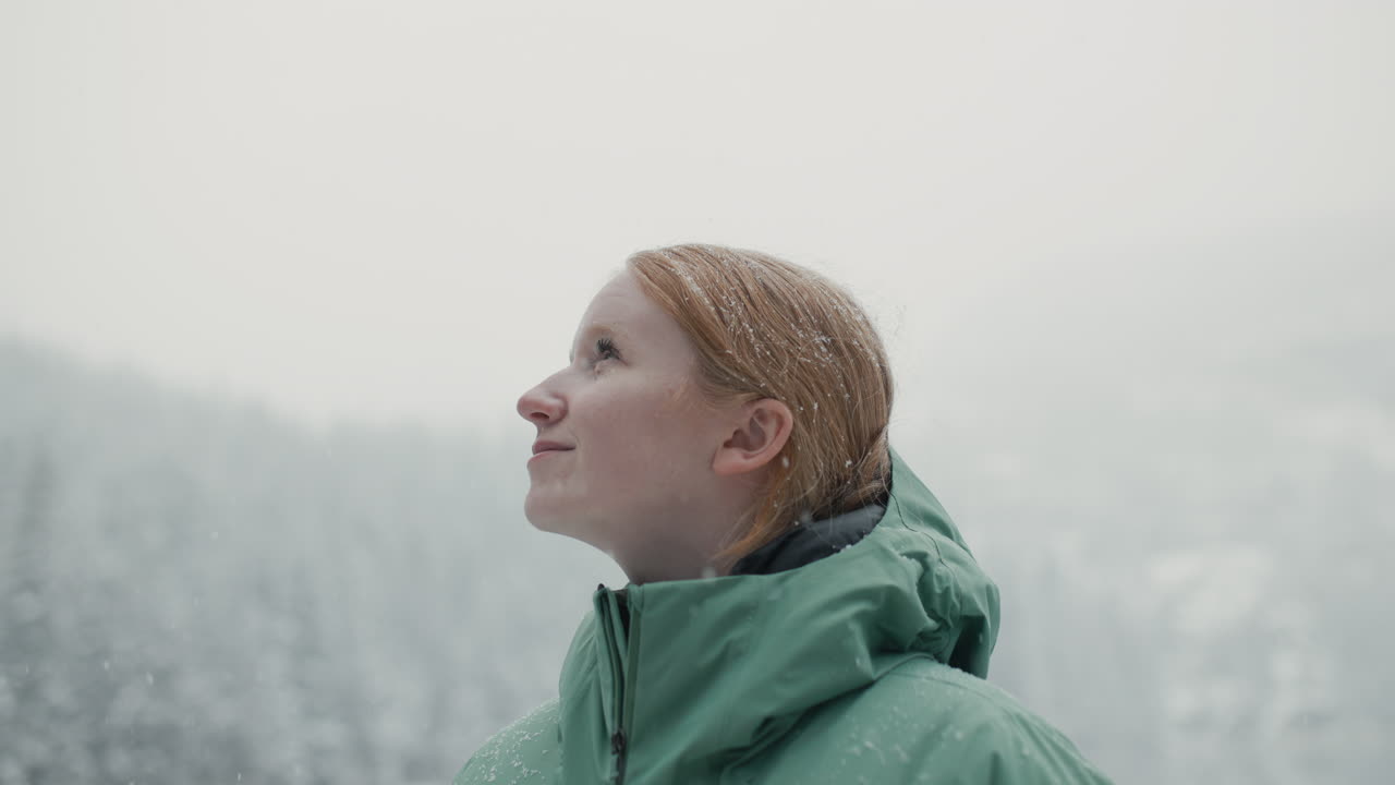 Woman enjoying a snowy day in the mountains