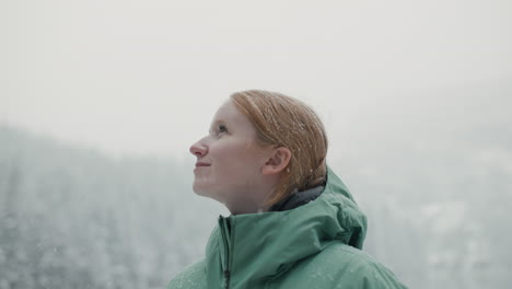 woman enjoying a snowy day in the mountains