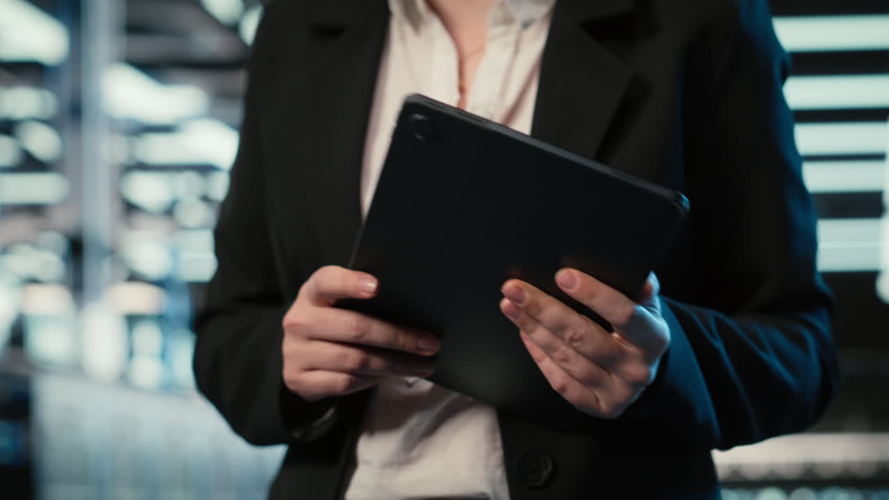 Closeup Of Programmer Walking In Data Center, Optimizing Server Load With Tablet