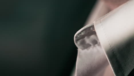 Close-up-handheld-panning-of-business-man's-t-shirt-white-collar