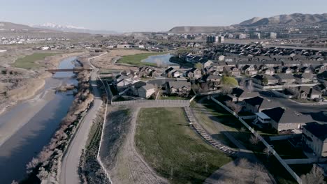 aerial approach of a suburban home with a large backyard deck and outdoor living space