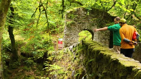 two people exploring a scenic stone bridge