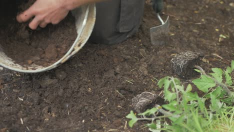 mixing compost and soil in bucket gardening