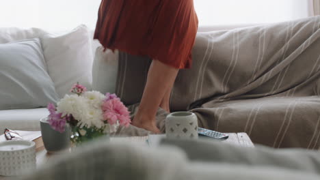 happy woman dancing on sofa at home having fun celebrating success enjoying funny dance feeling positive on weekend 4k footage