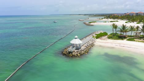 panoramic view of the kiosk at the entrance to the marina of cap cana with catamaran in the sea, blue waters and fresh air