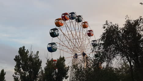 Khiva-Uzbekistan-Amusement-Park,-Ferris-Wheel-Spinning-on-Golden-Hour,-Wide-View