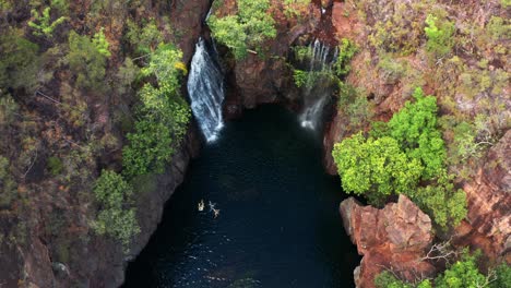 tourists swim on the creek with florence falls within litchfield national park in the northern territory of australia