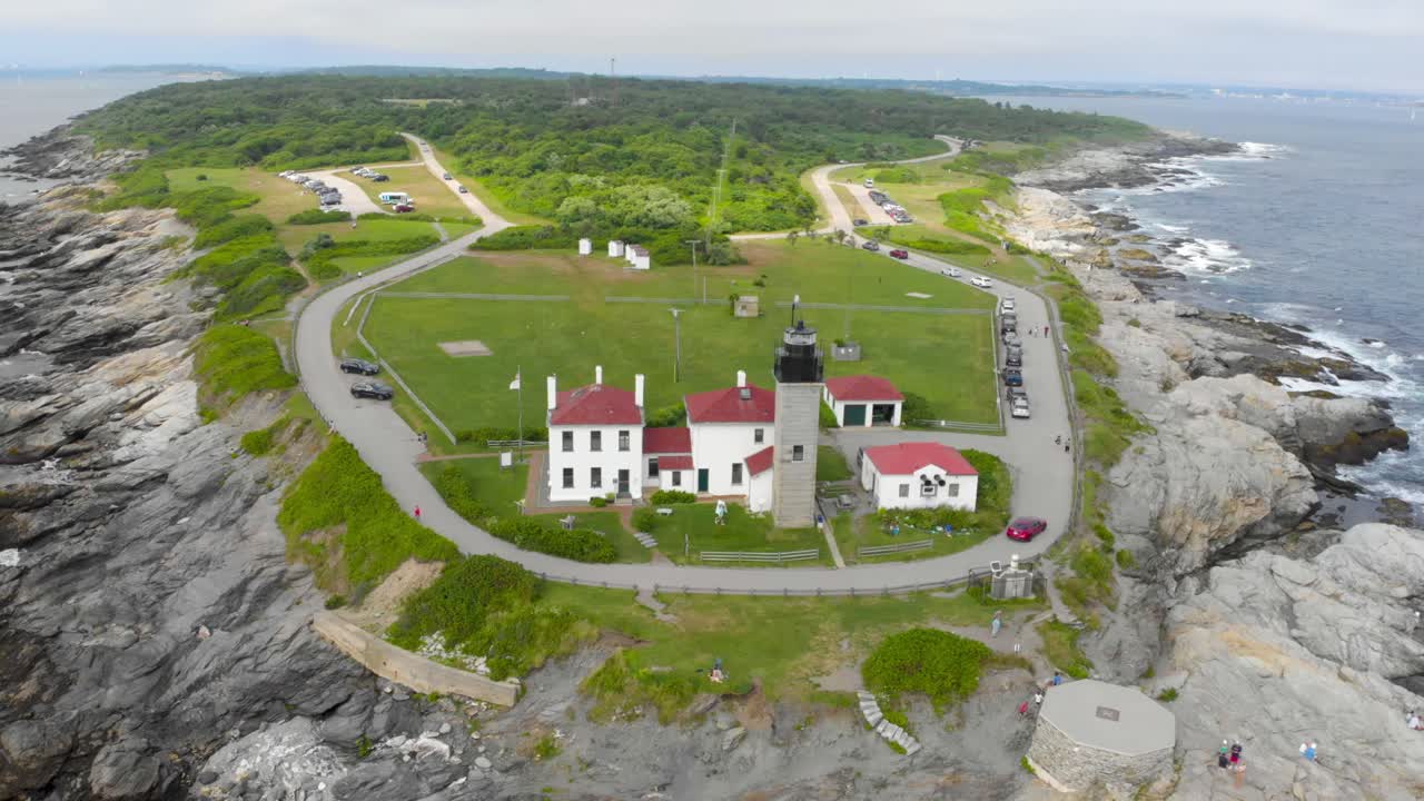Stunning drone footage orbiting a lighthouse on a scenic peninsula in Jamestown, Rhode Island. Perfect for coastal landscapes, travel, and aerial footage