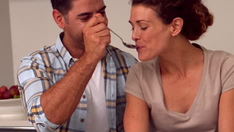 happy couple having breakfast in the kitchen