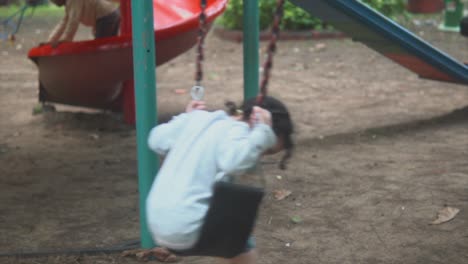 Slowmotion-shot-of-little-girl-in-a-swing-by-herself