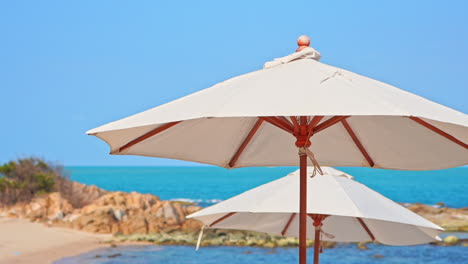 cerca de sombrillas de playa, sombrillas y mar tropical en la brisa de verano