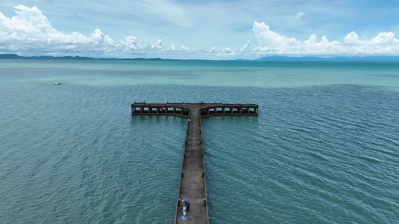 Aerial drone view of Than Mayom Pier extending into turquoise sea waters on Koh Chang Island, Trat, Thailand, showing calm coastal scenery and tropical travel destination beauty