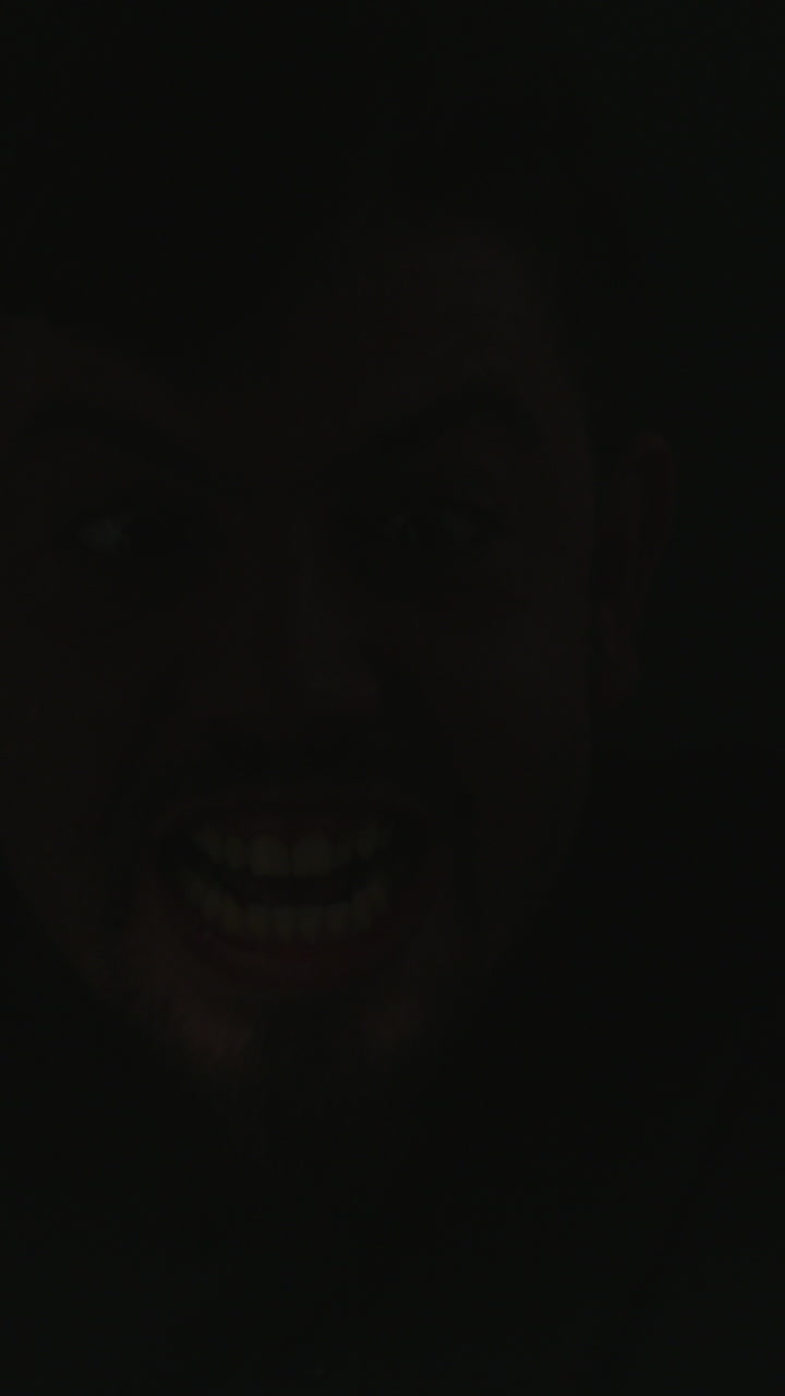 Scary Man's Menacing Face Appears and Disappears in Darkness