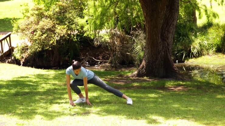 Fit girl stopping to stretch her legs on a jog