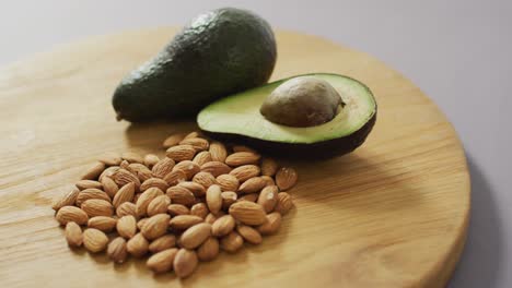 Video-of-almonds-and-avocado-on-wooden-background