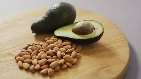 video of almonds and avocado on wooden background