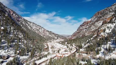 beautiful drone aerial views exiting ouray, colorado on a bright day in winter