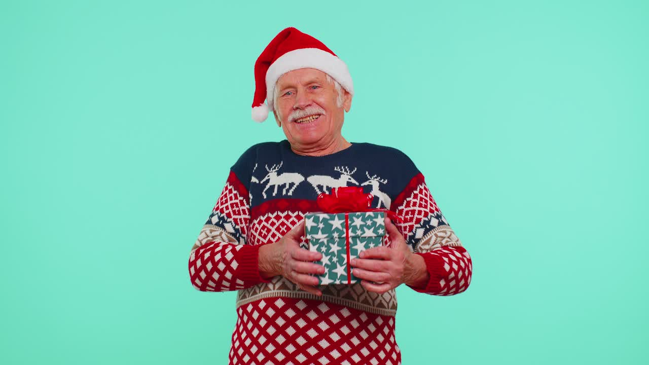 Grandfather man in sweater santa christmas getting present gift box expressing amazement happiness
