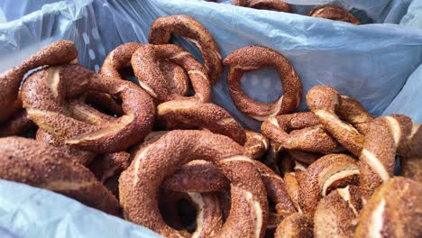 a pile of freshly baked turkish simit covered in sesame seeds