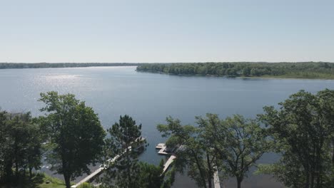 a sunny aerial view of half moon lake, wisconsin, surrounded by dense forests.