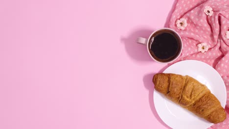 paper card note appear from envelope next to fresh croissant and cup of coffee. stop motion