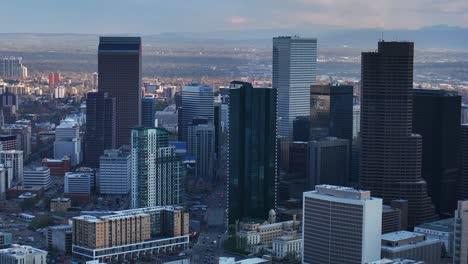 downtown denver cityscape city tall skyscraper buildings aerial drone colorado spring summer afternoon sunset mountains range landscape city park rhino pan clouds sunny panorama upwards motion