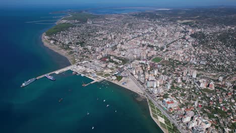 Aerial-Vlora:-Coastal-City-by-the-Port,-Embracing-the-Sea's-Beauty,-a-Top-Summer-Vacation-Destination-in-Albania's-Splendid-Landscape