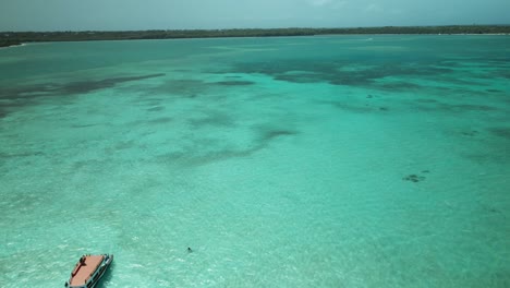 Amazing-aerial-view-of-nylon-pool,-Tobago-with-a-glass-bottom-boat-in-the-foreground