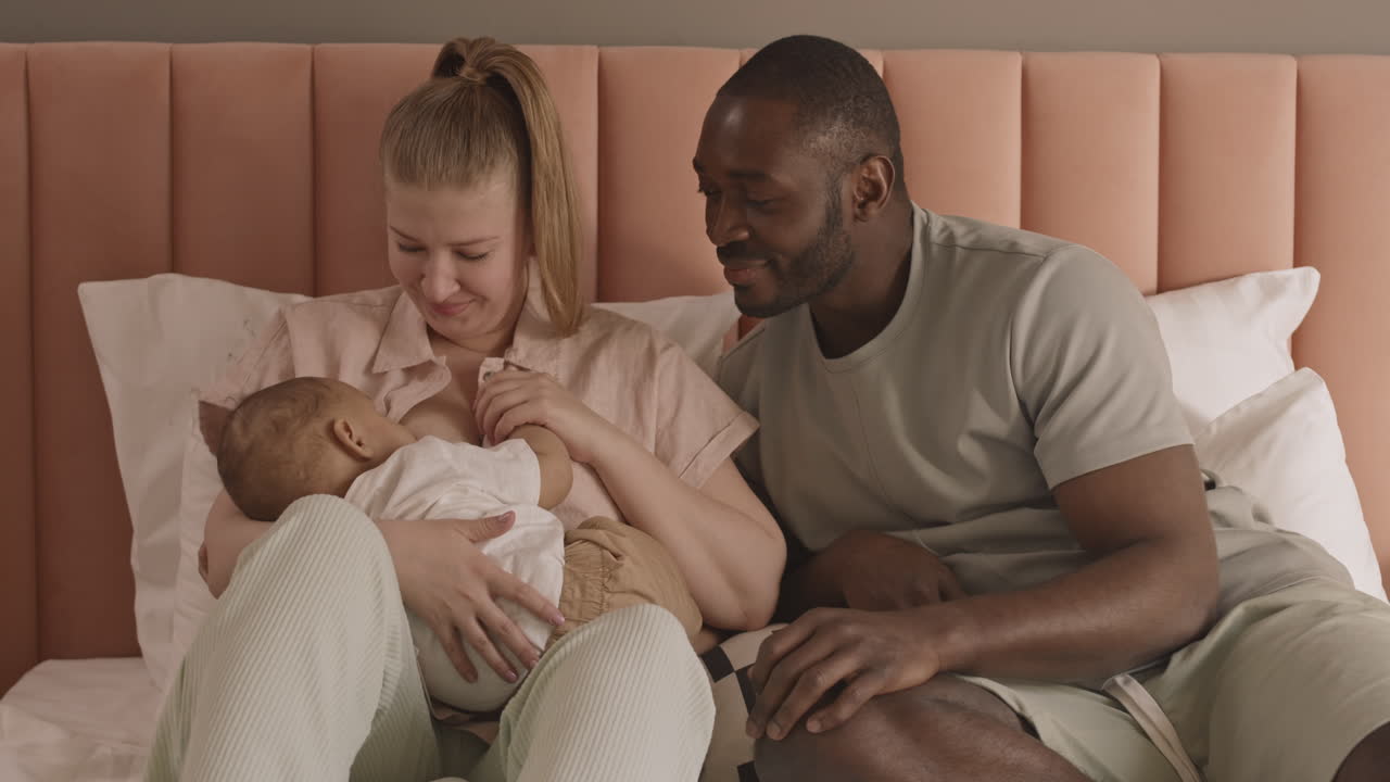 Man Watching Wife Breastfeeding Child