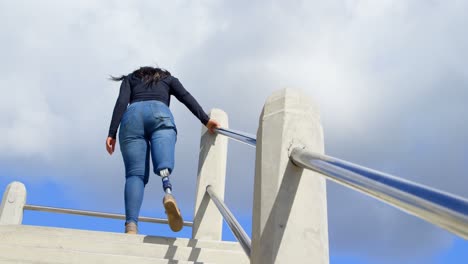 Disabled-woman-walking-upstairs-on-a-sunny-day-4k-