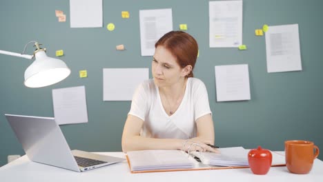 the woman looking at the documents is thoughtful.