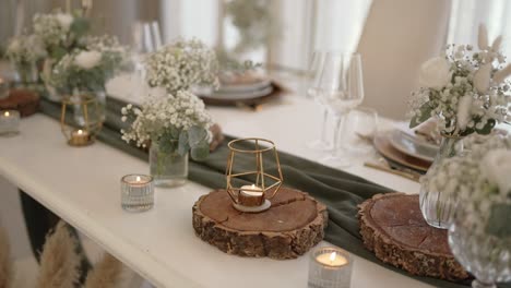 wedding table decorated with candles, flowers, and wooden accents in rustic style