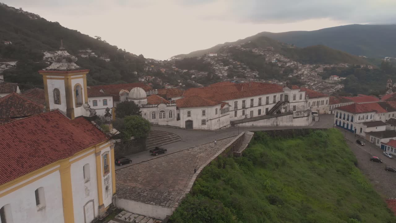 Our Lady of Mercy and Charity church with in the background the city centre of Ouro Preto, Minas Gerais, Brazil, with the mining museum and observatory of the Federal University