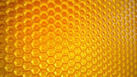 Endless-animation-showing-the-infinite-honeycomb-filled-with-honey.-Closeup-at-delicious-sweet-substance-in-its-original-container.-Physical-accurate-material-with-immersive-reflections.-Loopable.-HD