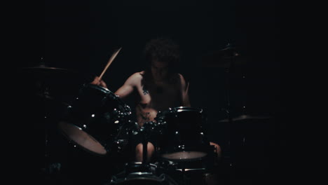 drummer in dark studio