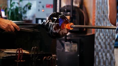 Team-of-glassblowers-shaping-a-molten-glass