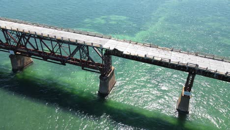 gorgeous orbiting aerial of the old bahia honda railroad bridge in the florida keys, florida, usa